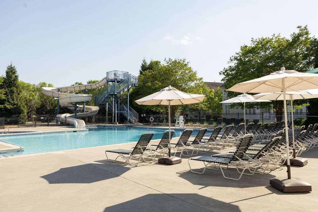 Pool area with lounge chairs and umbrellas