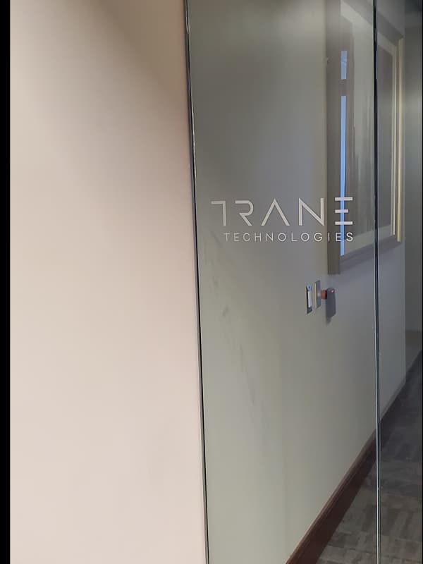 Glass door with TRAN Technologies branding