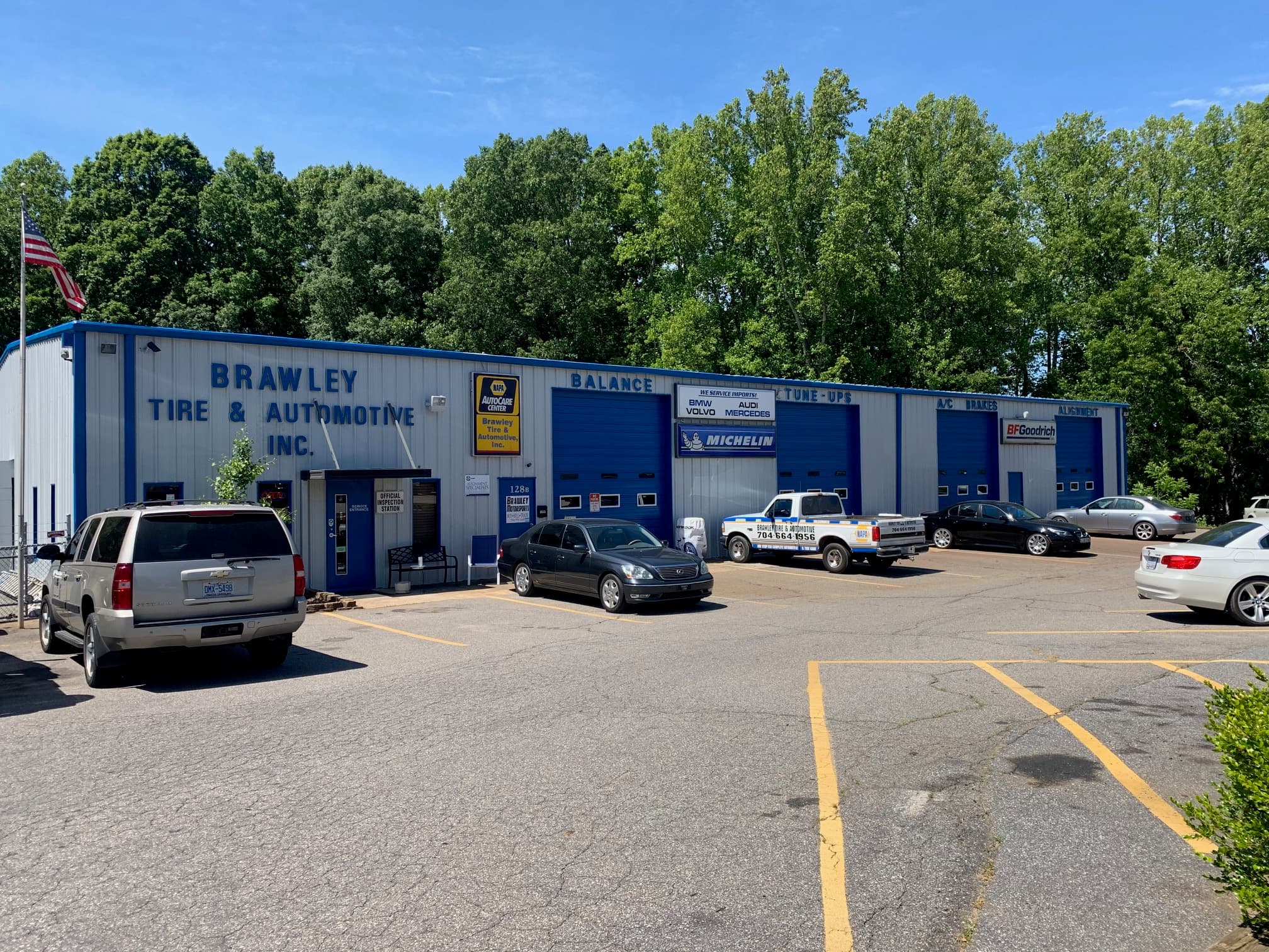 Storefront exterior with signage and vehicles
