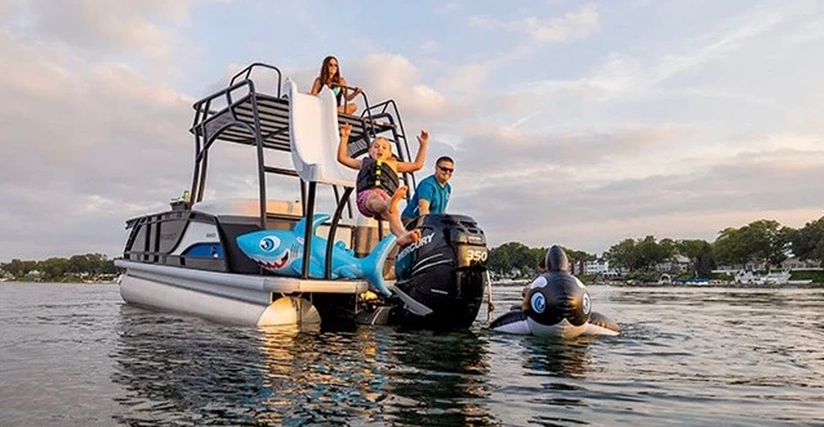 Family on pontoon boat with water slide