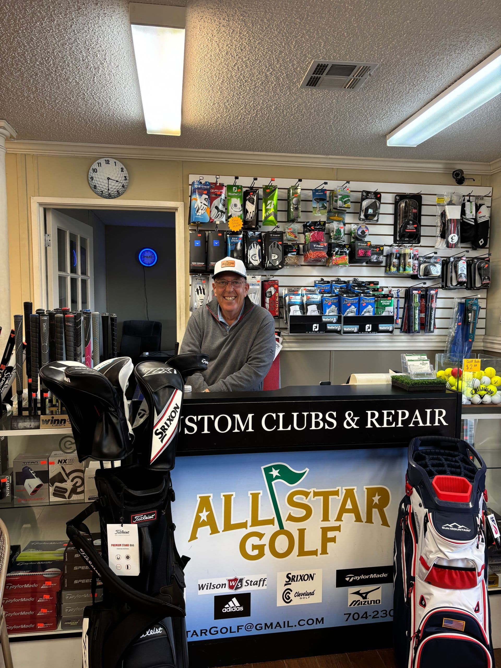 Interior shop with golf clubs, bags and TV