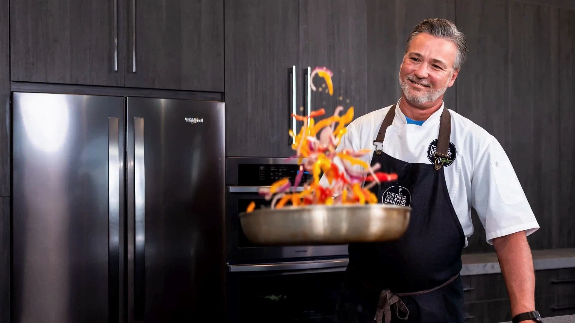 Chef tossing colorful vegetables in a pan