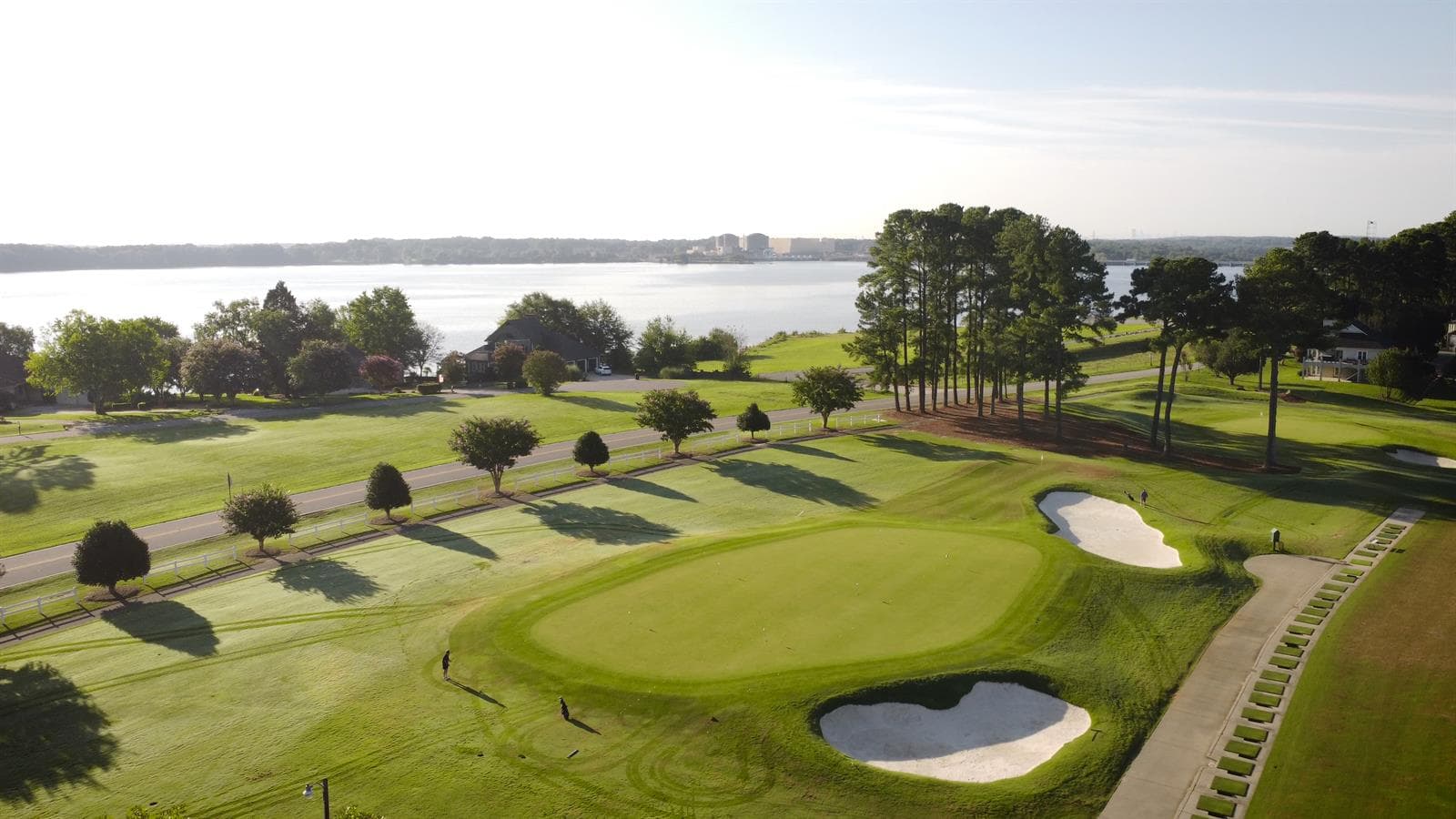 Aerial view of golf course green and lake