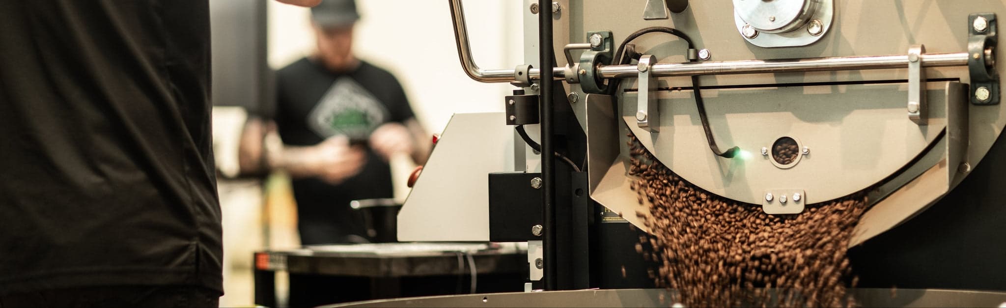 Coffee roasting machine with beans pouring, roaster in action