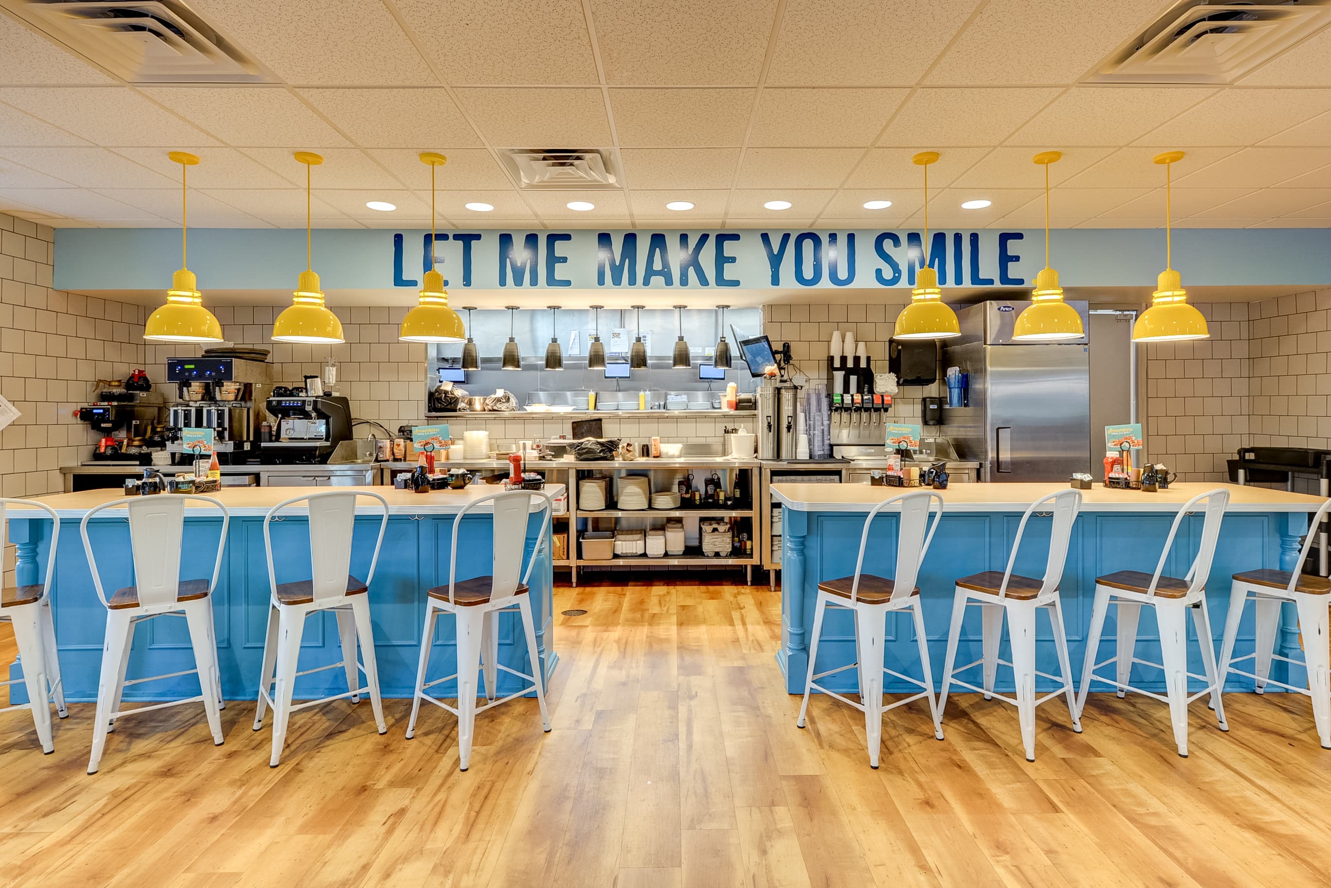 Restaurant interior with counter seating and kitchen