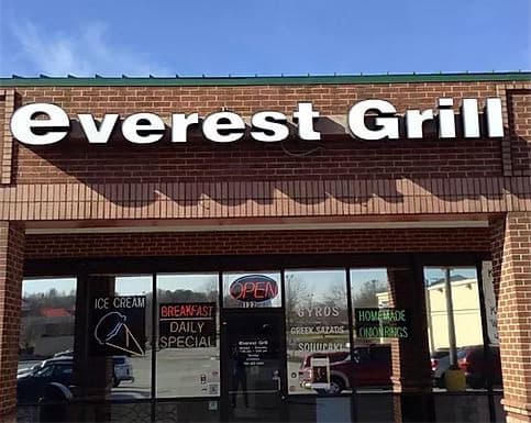 Everest Grill storefront with sign and windows