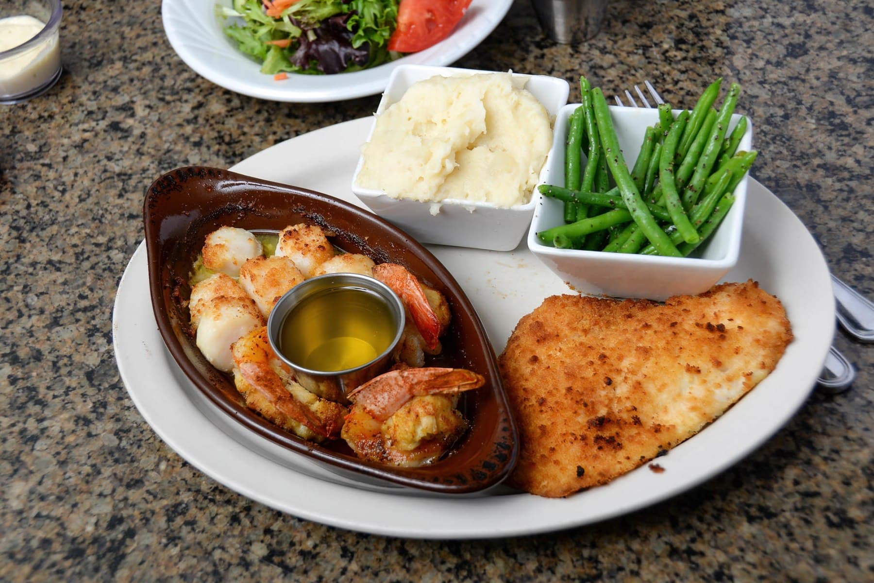 Seafood platter with shrimp, fish, mashed potatoes, green beans