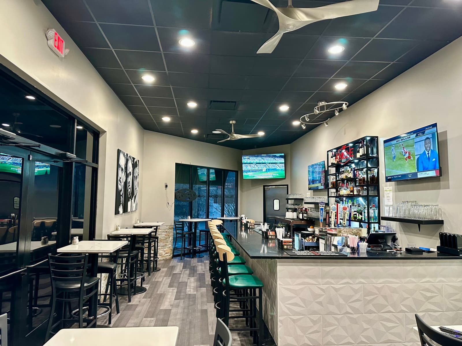 Interior of restaurant bar with TVs and seating