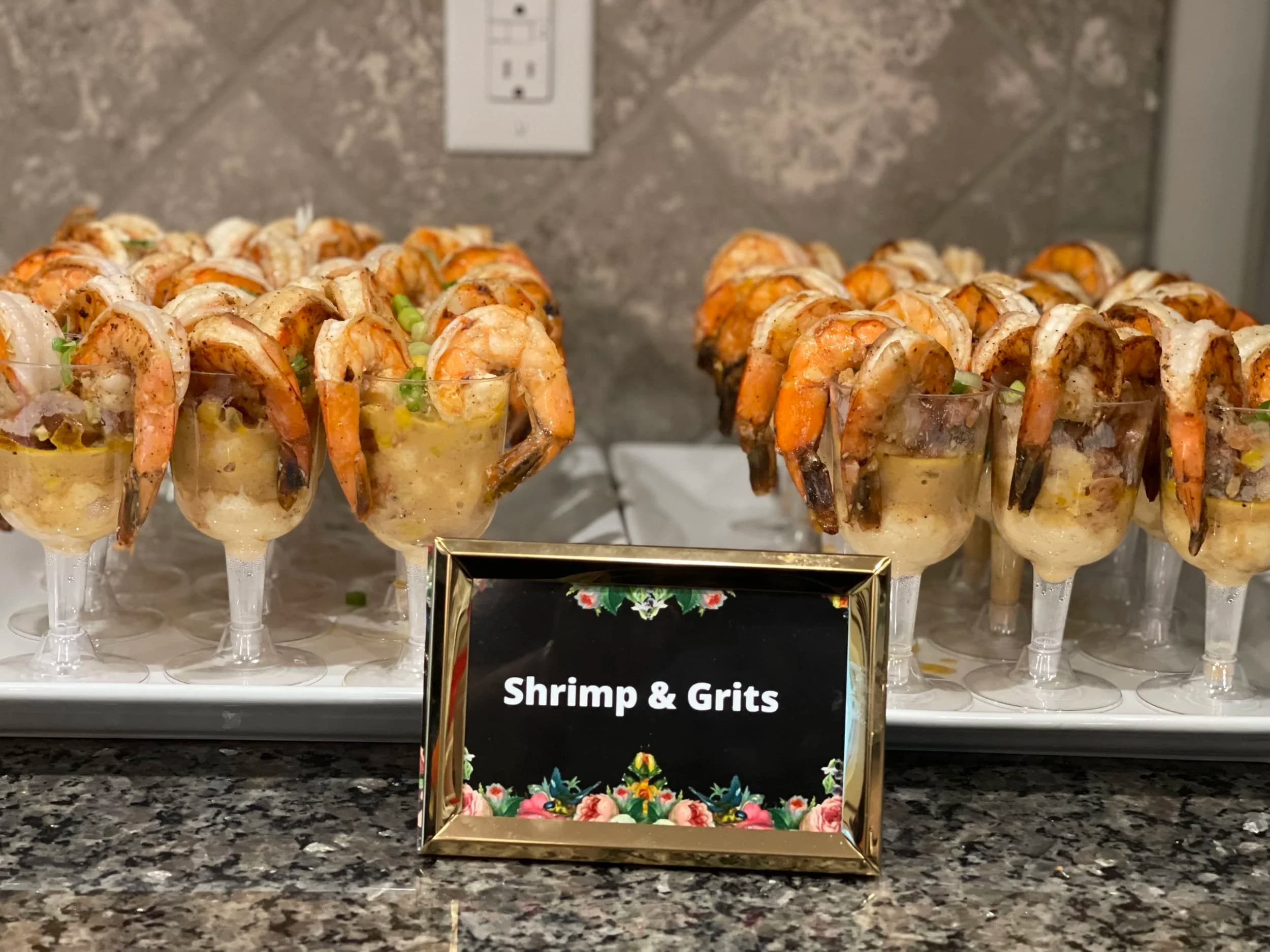 Shrimp & grits appetizers displayed on catering table