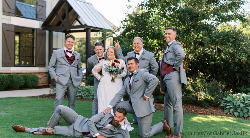 Wedding party posing in front of venue building