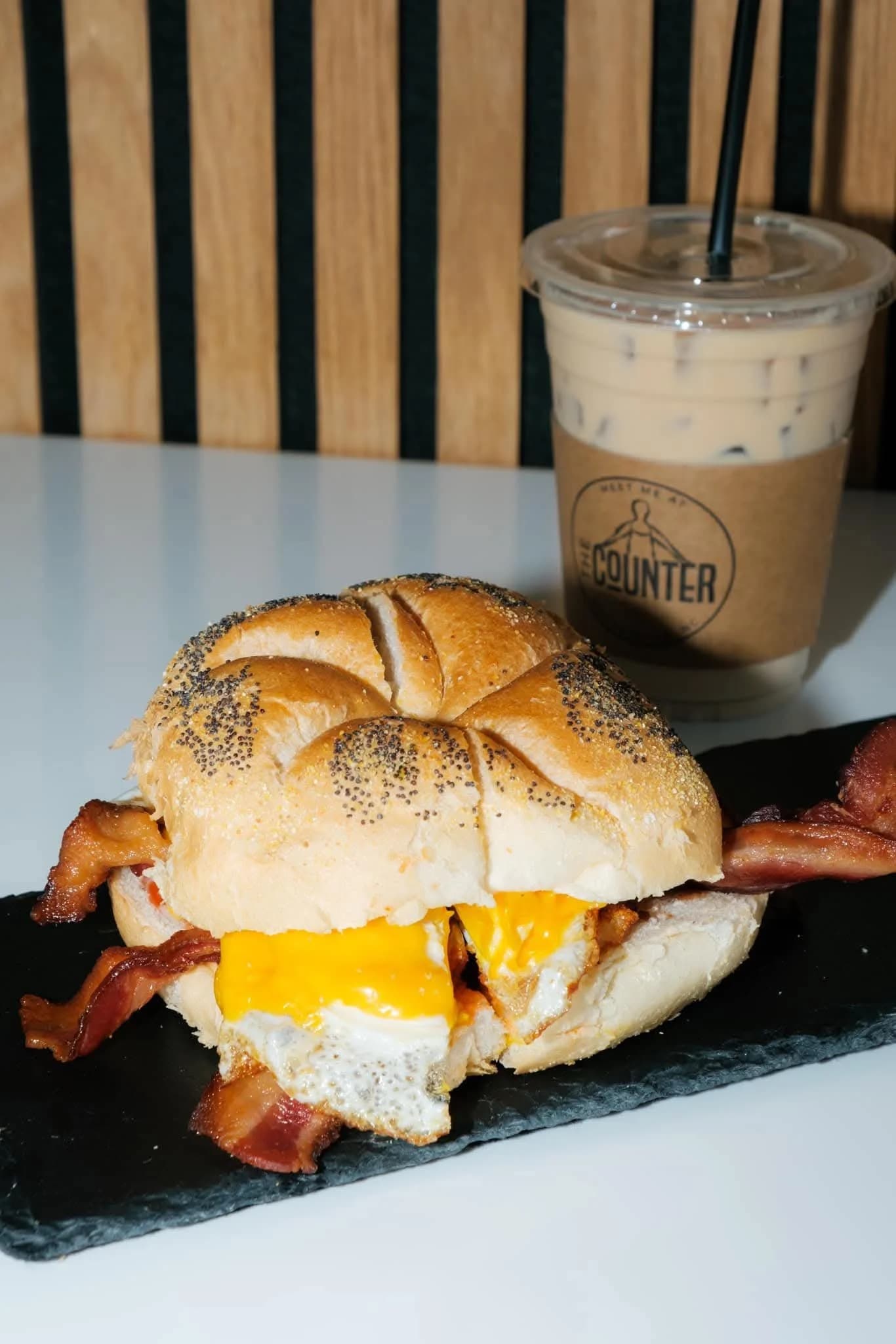 Sandwich and iced coffee with The Counter branded cup