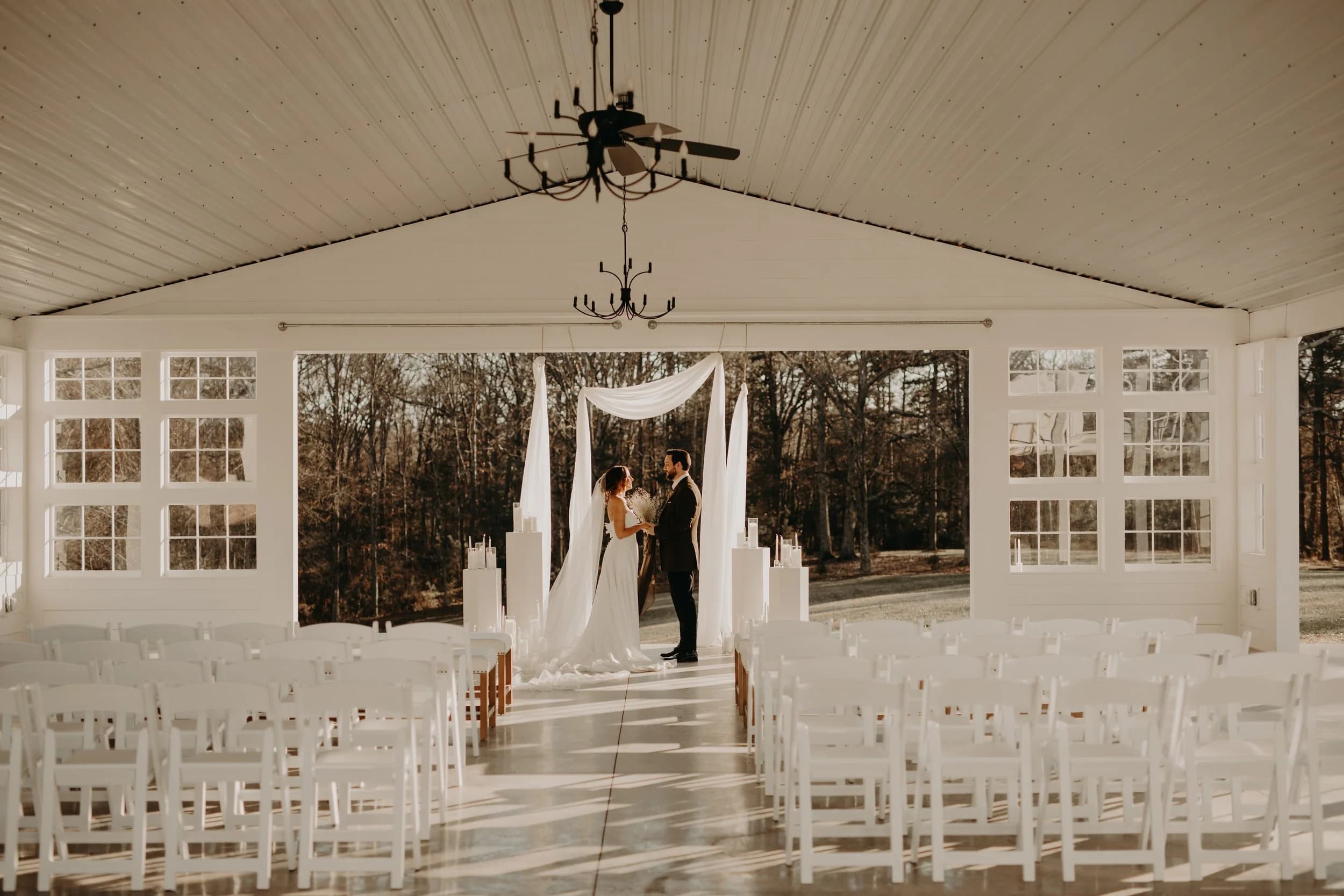 White barn venue exterior with guests on patio