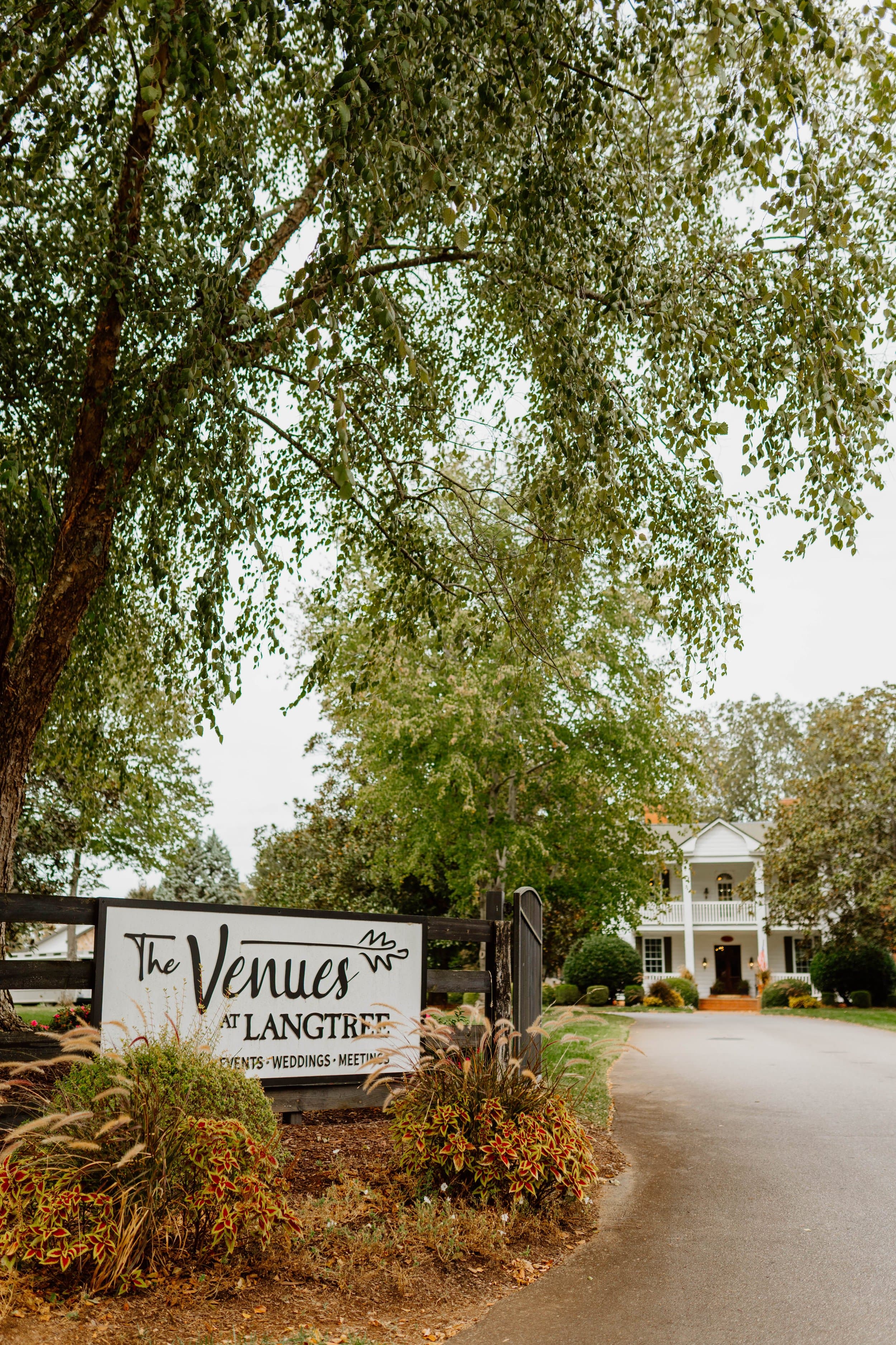 Venue's rustic exterior building with landscaping