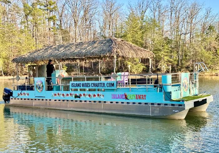 Island Vibes charter boat with thatched roof canopy
