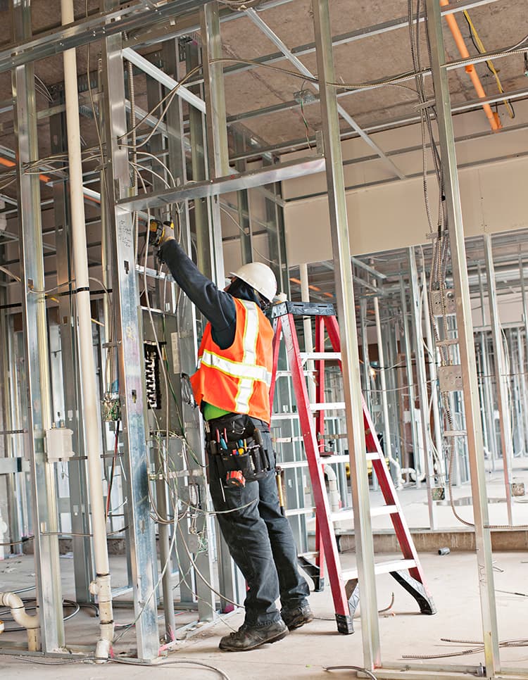 Electrician working on building interior wiring