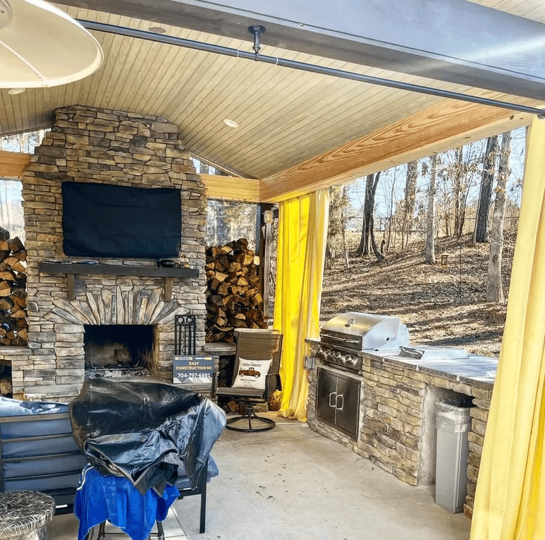 Outdoor patio with fireplace and kitchen setup