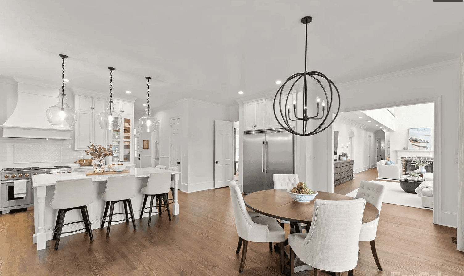 Modern white kitchen with island and pendants