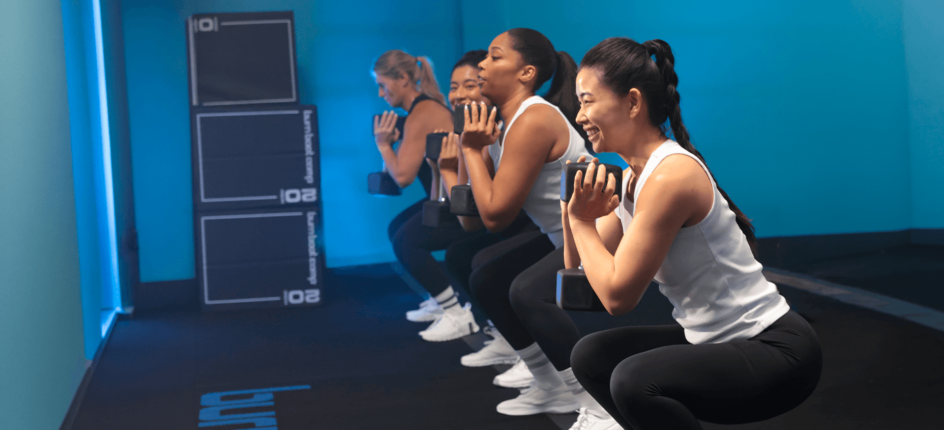 Group fitness class in modern blue gym studio