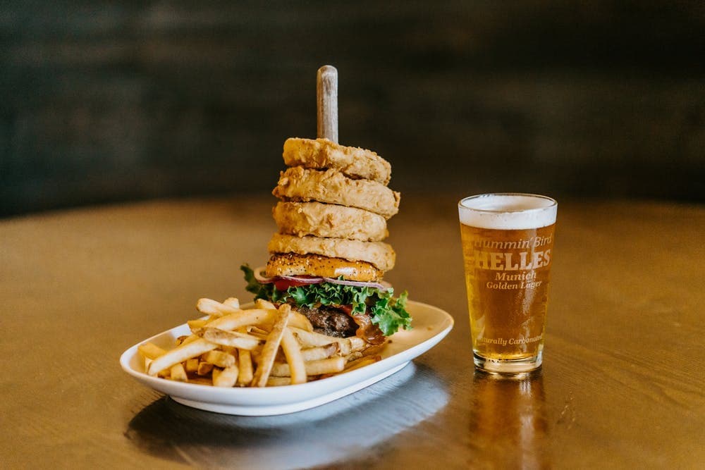 Gourmet burger with stacked patties and fries