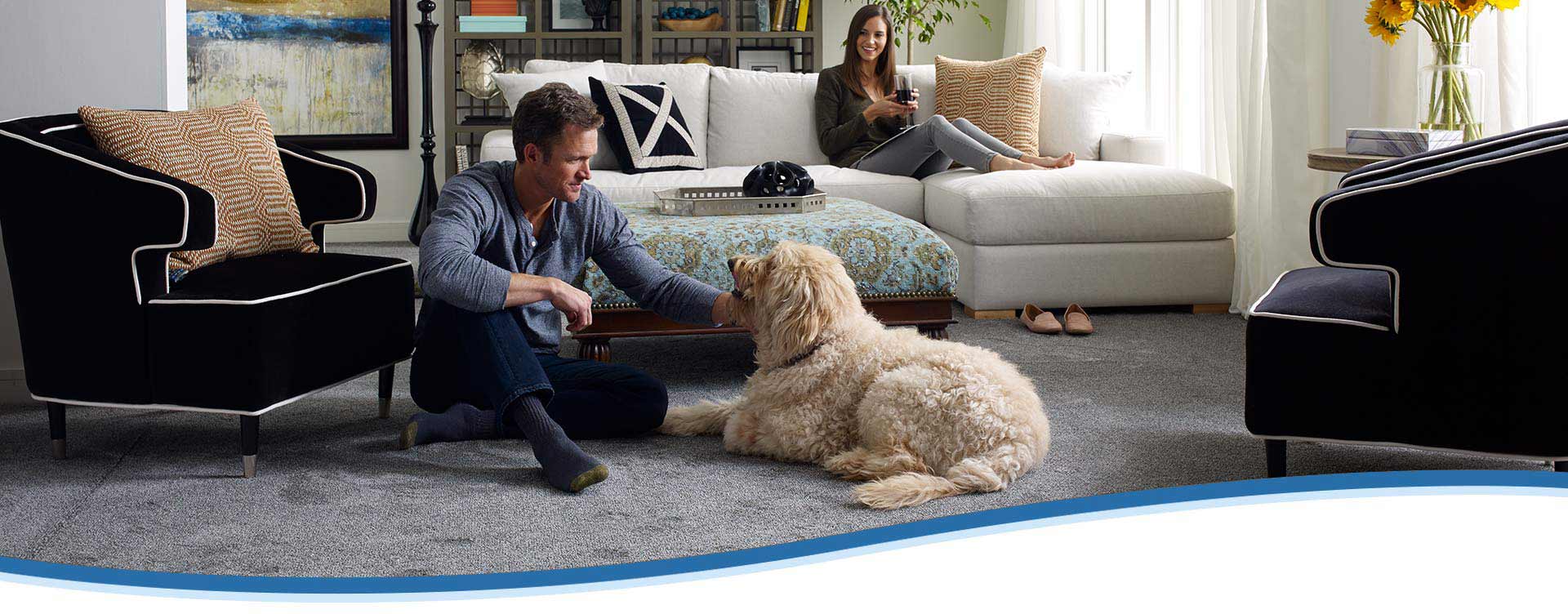 Living room with carpet flooring and family