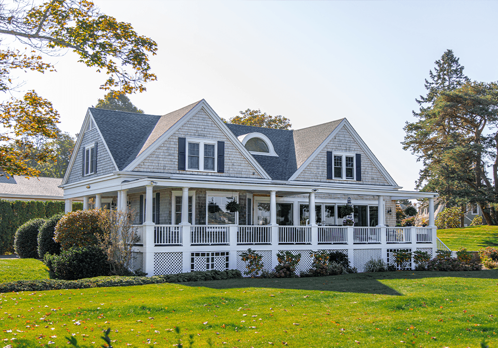 House with white porch and dark roof