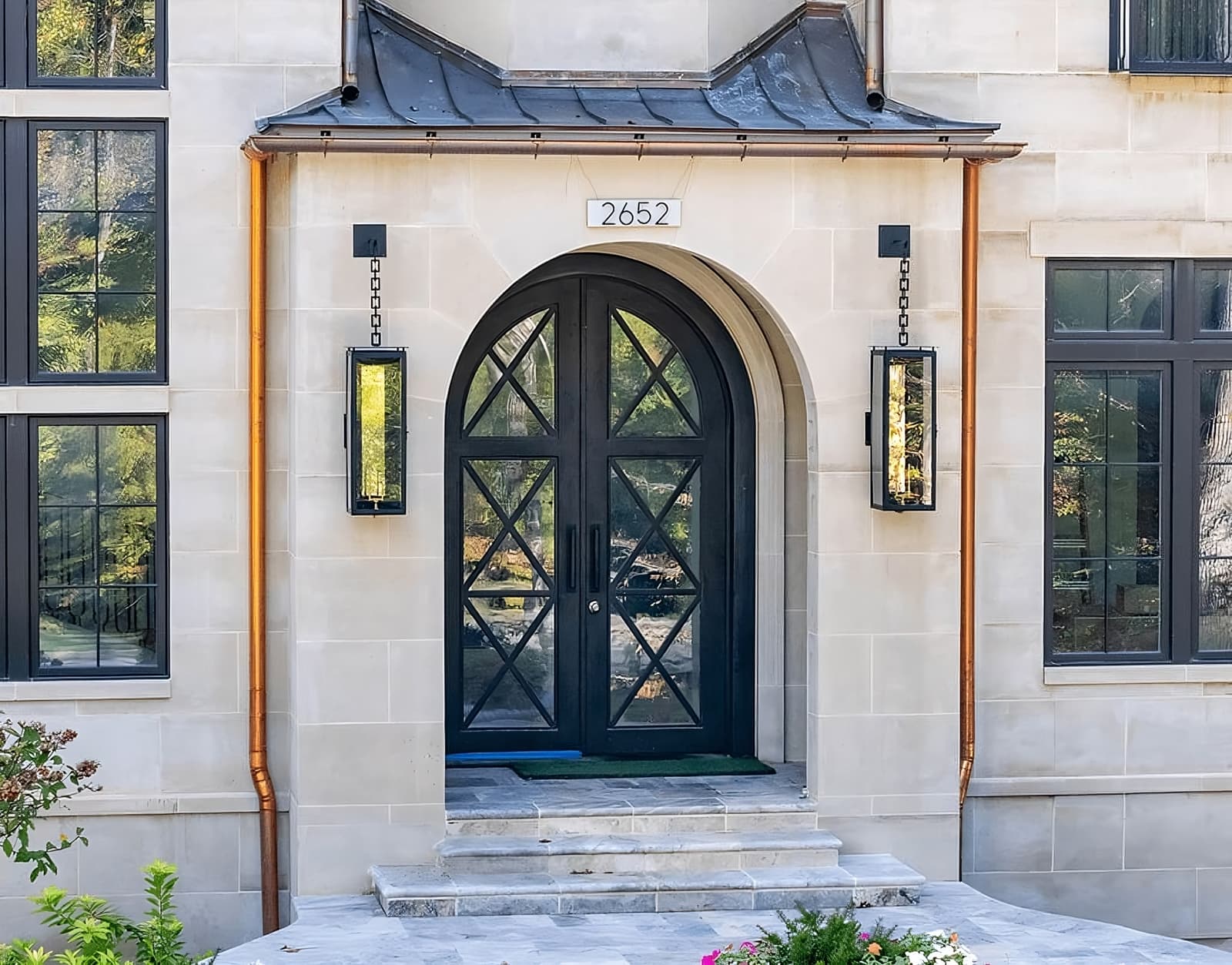 Black double doors with decorative X-pattern glass