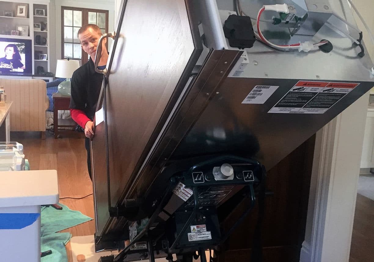 Technician installing or repairing appliance
