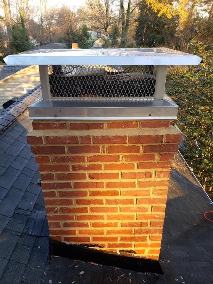Chimney cap and metal flashing on brick chimney
