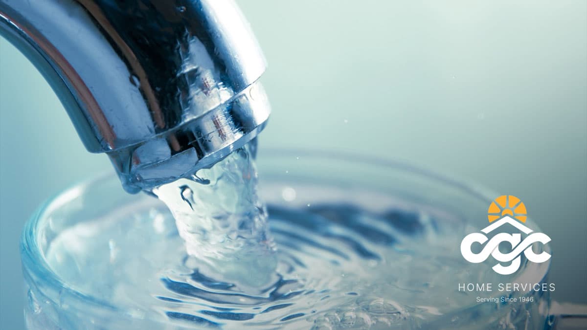 Water flowing from faucet into glass
