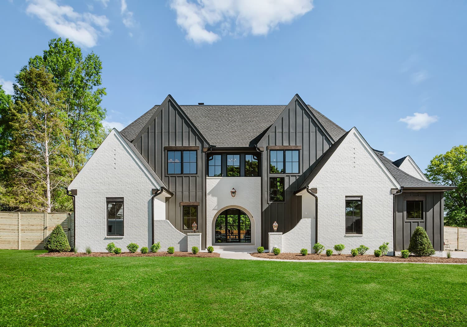 Modern home exterior with white brick and black trim