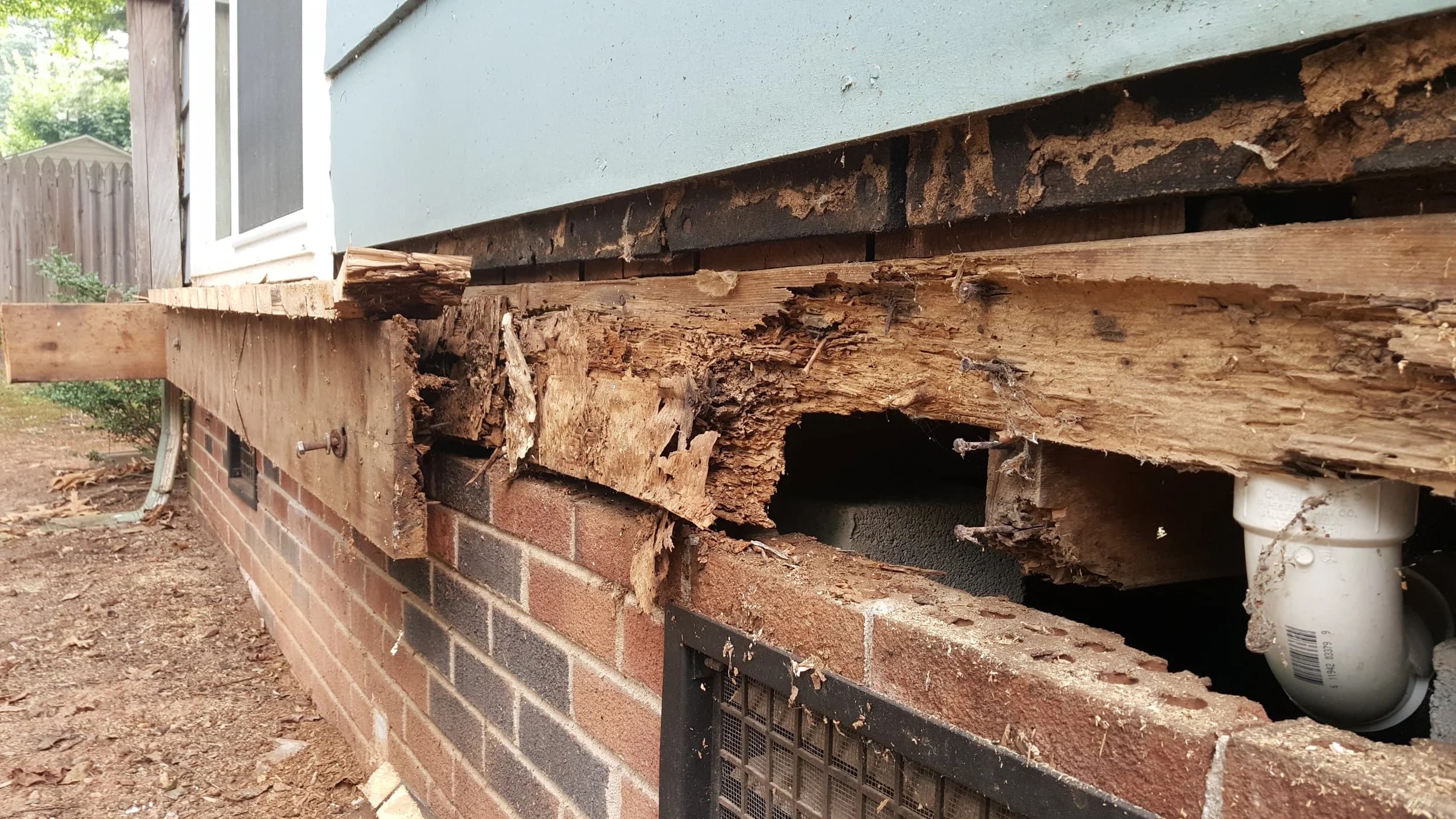 Severe wood rot damage under house foundation