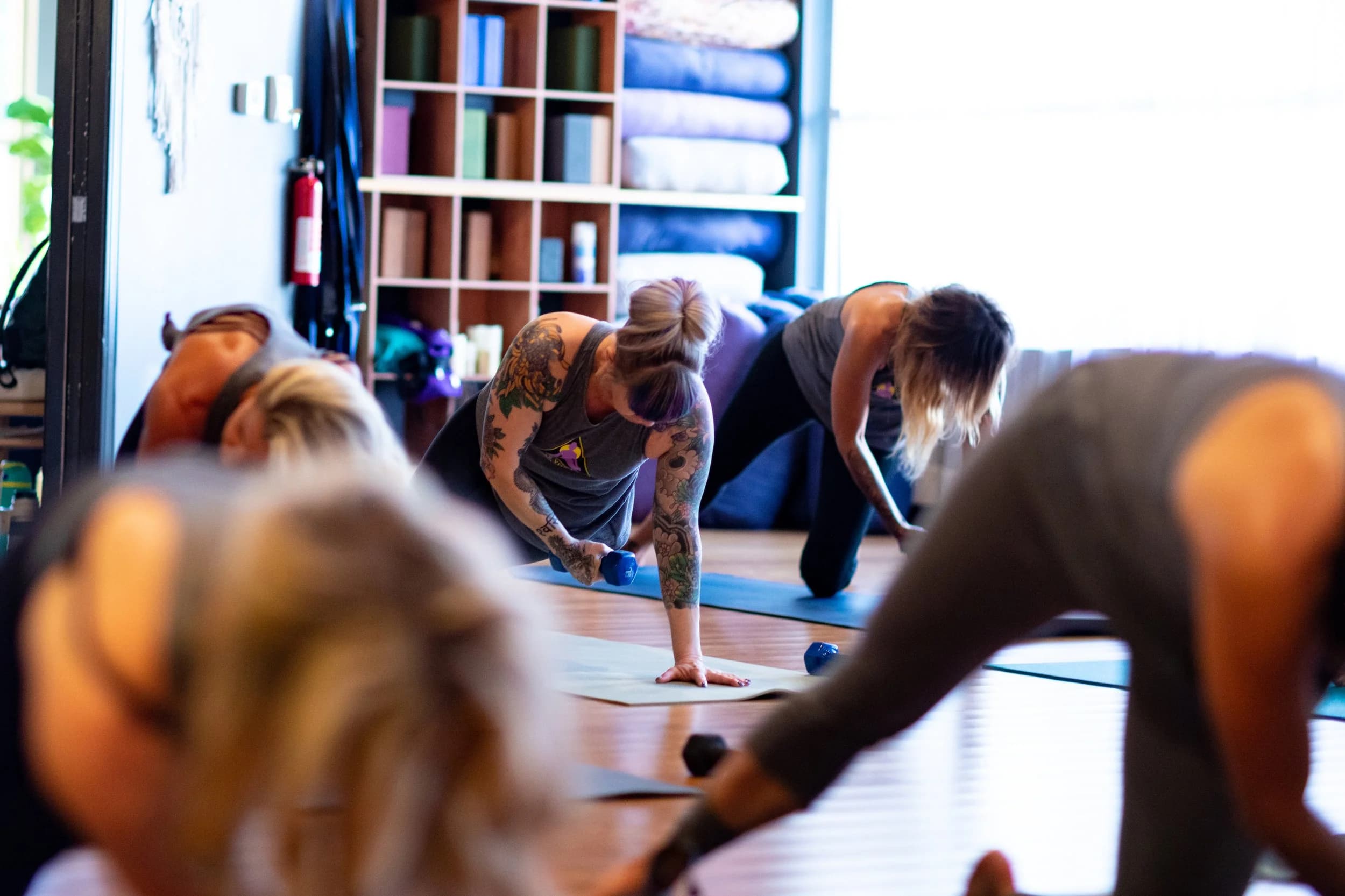 Yoga class in progress, downward dog pose
