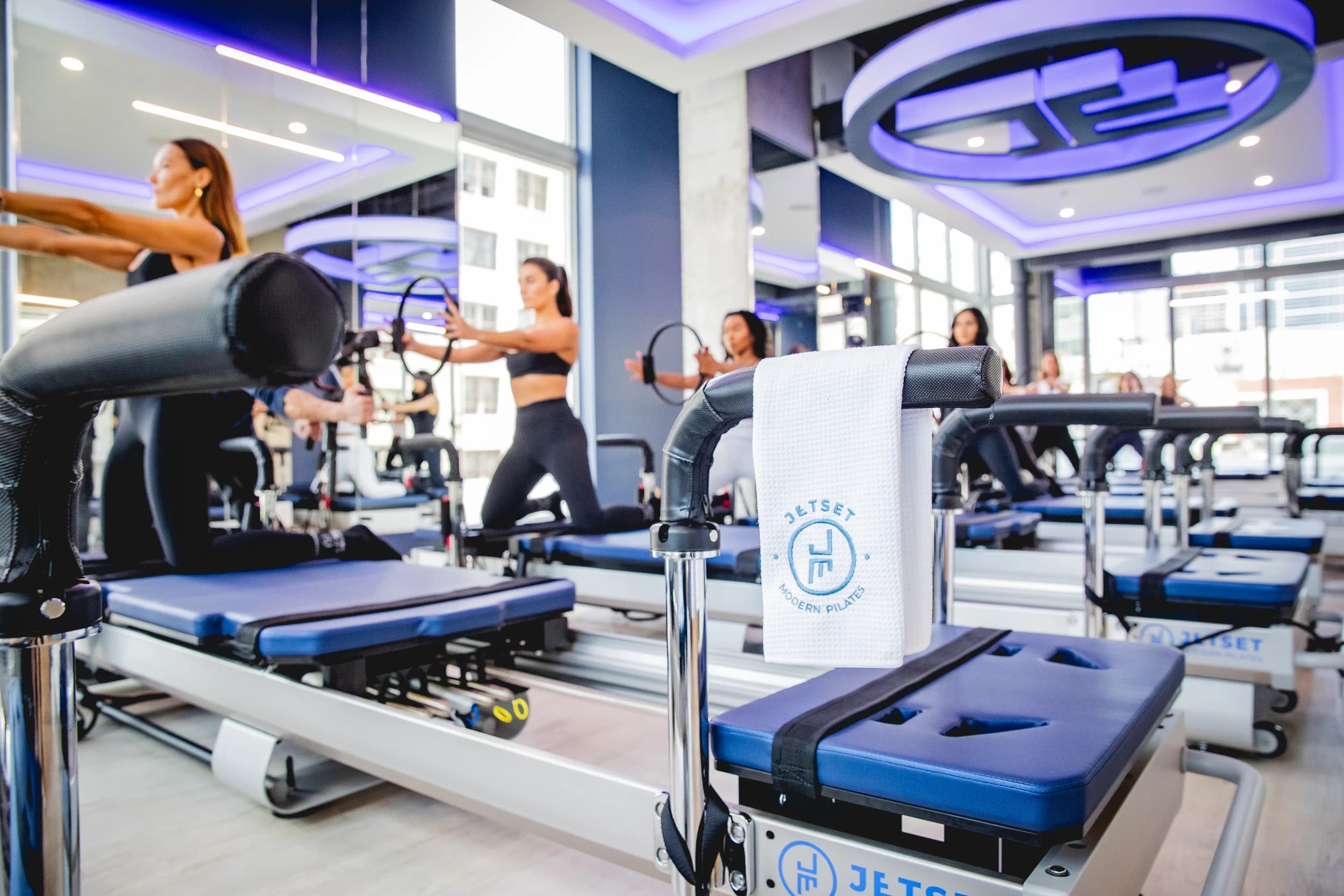 Indoor pilates studio with reformers and blue lighting