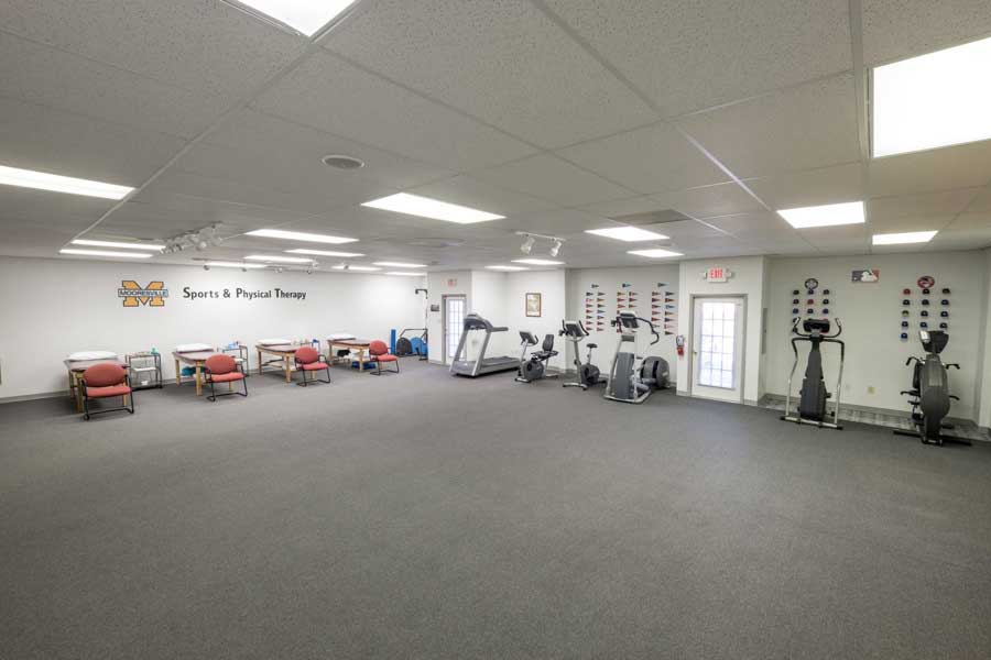 Interior facility with cardio equipment and treatment tables