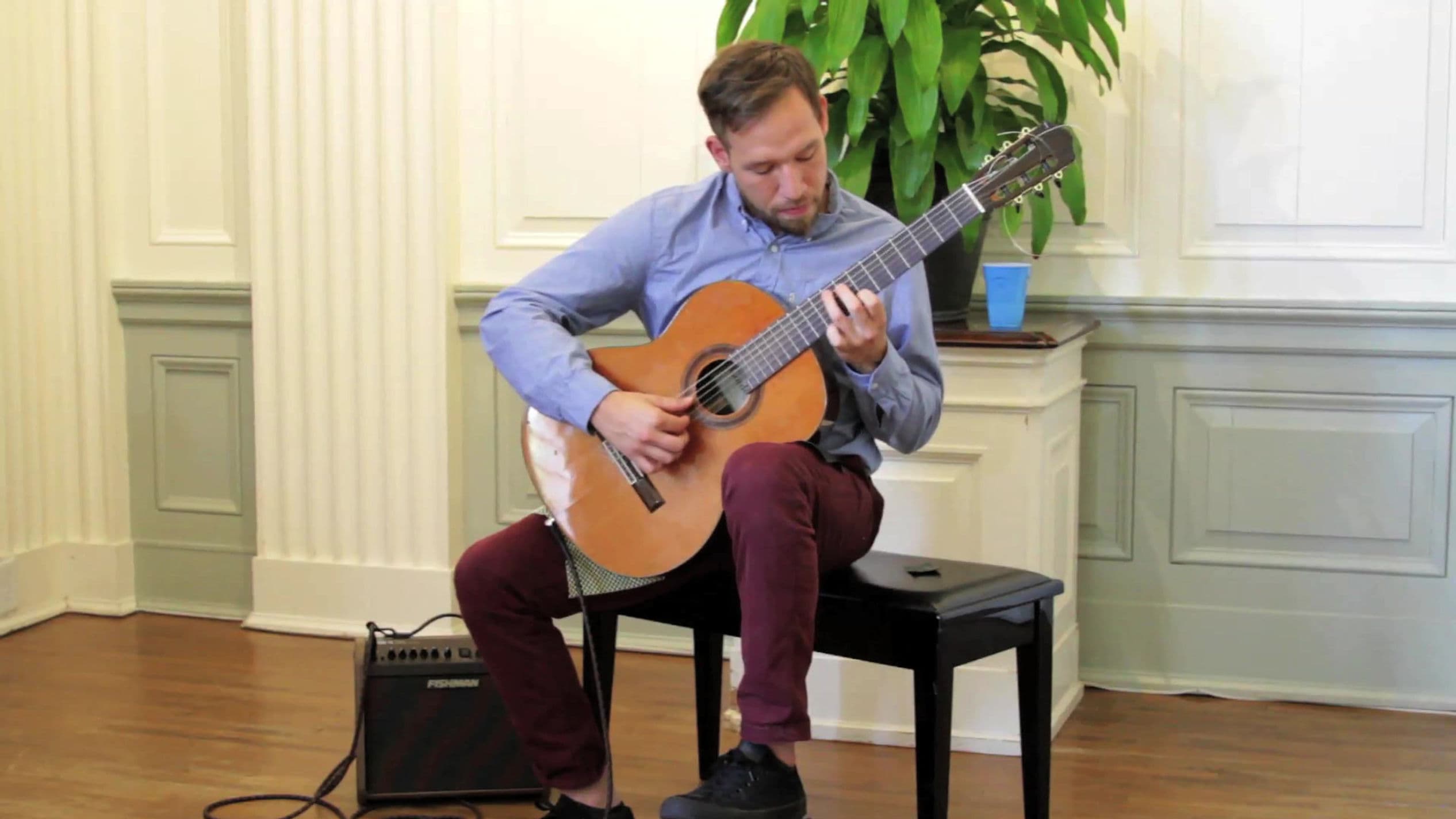 Guitarist performing in elegant interior space