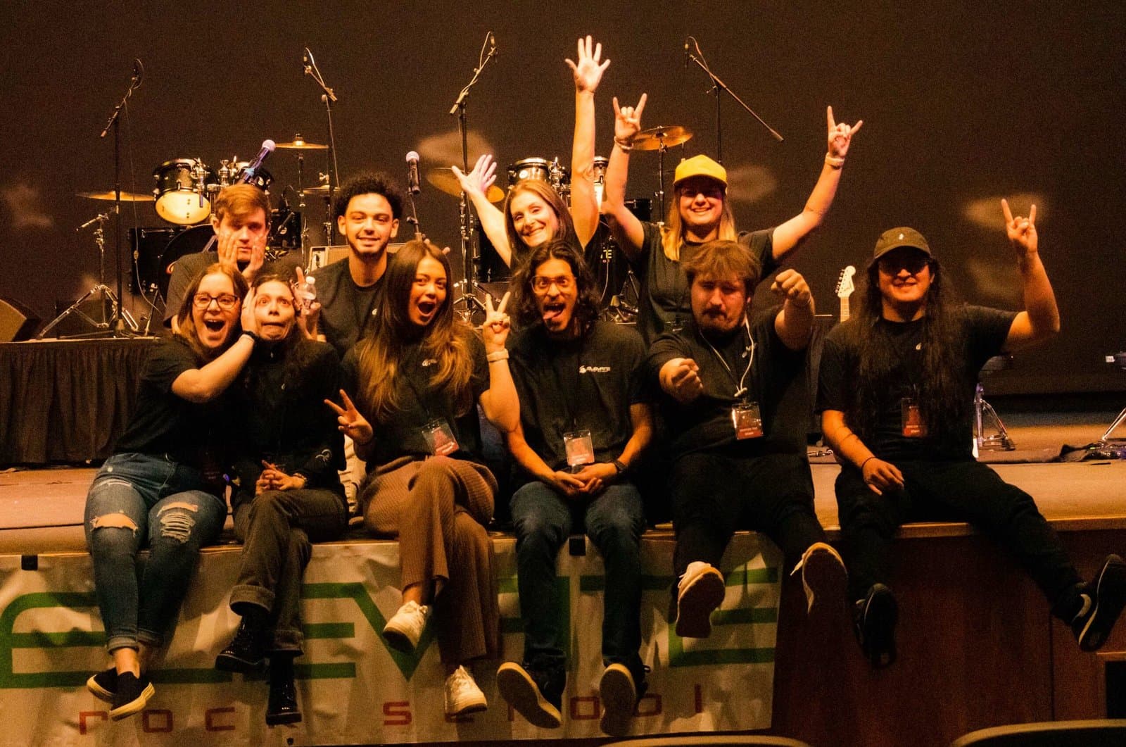 Group of music students celebrating on stage