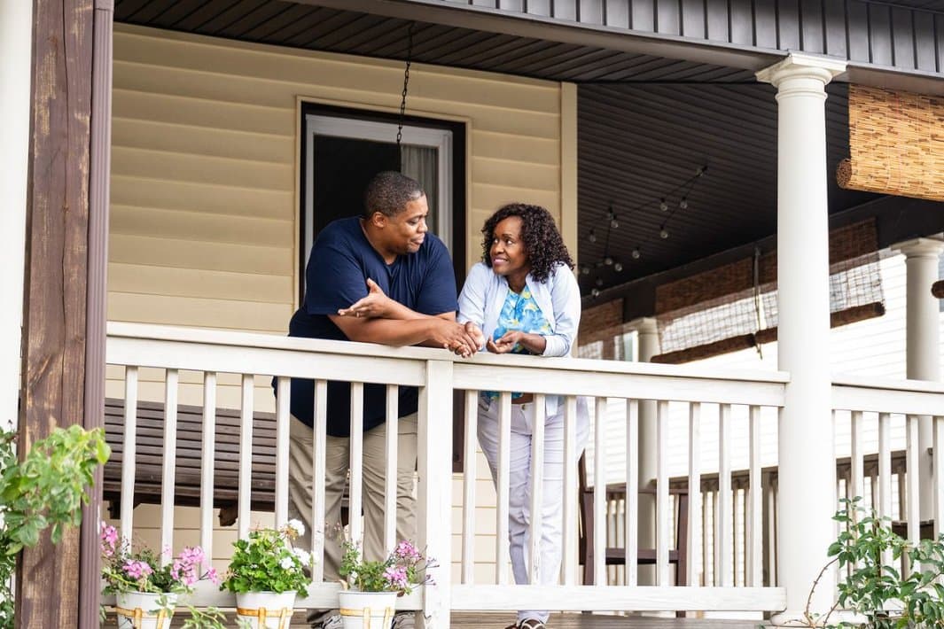 Man and woman on residential front porch