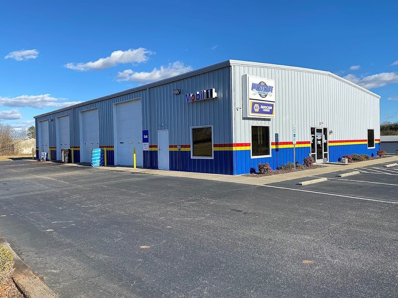 Storefront exterior with Mobil sign and service bays