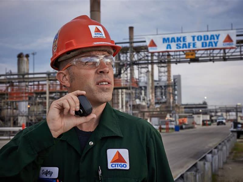Worker at industrial refinery facility with CITGO branding