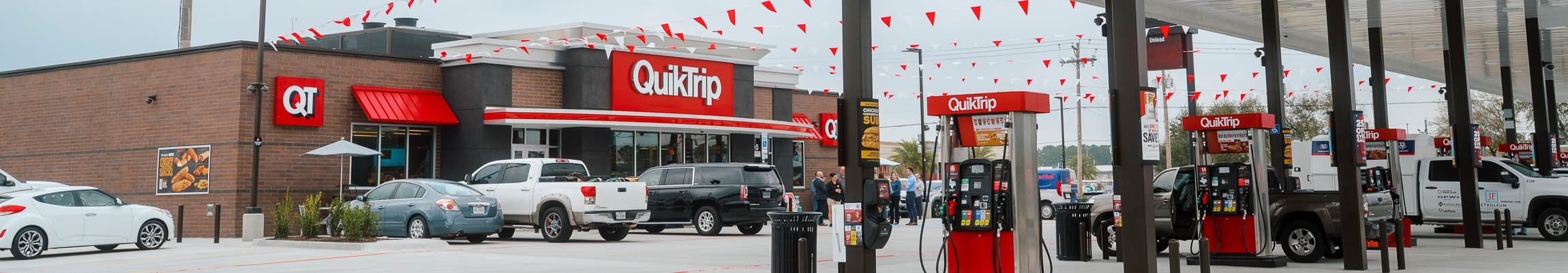 QuikTrip storefront with gas pumps and parking lot