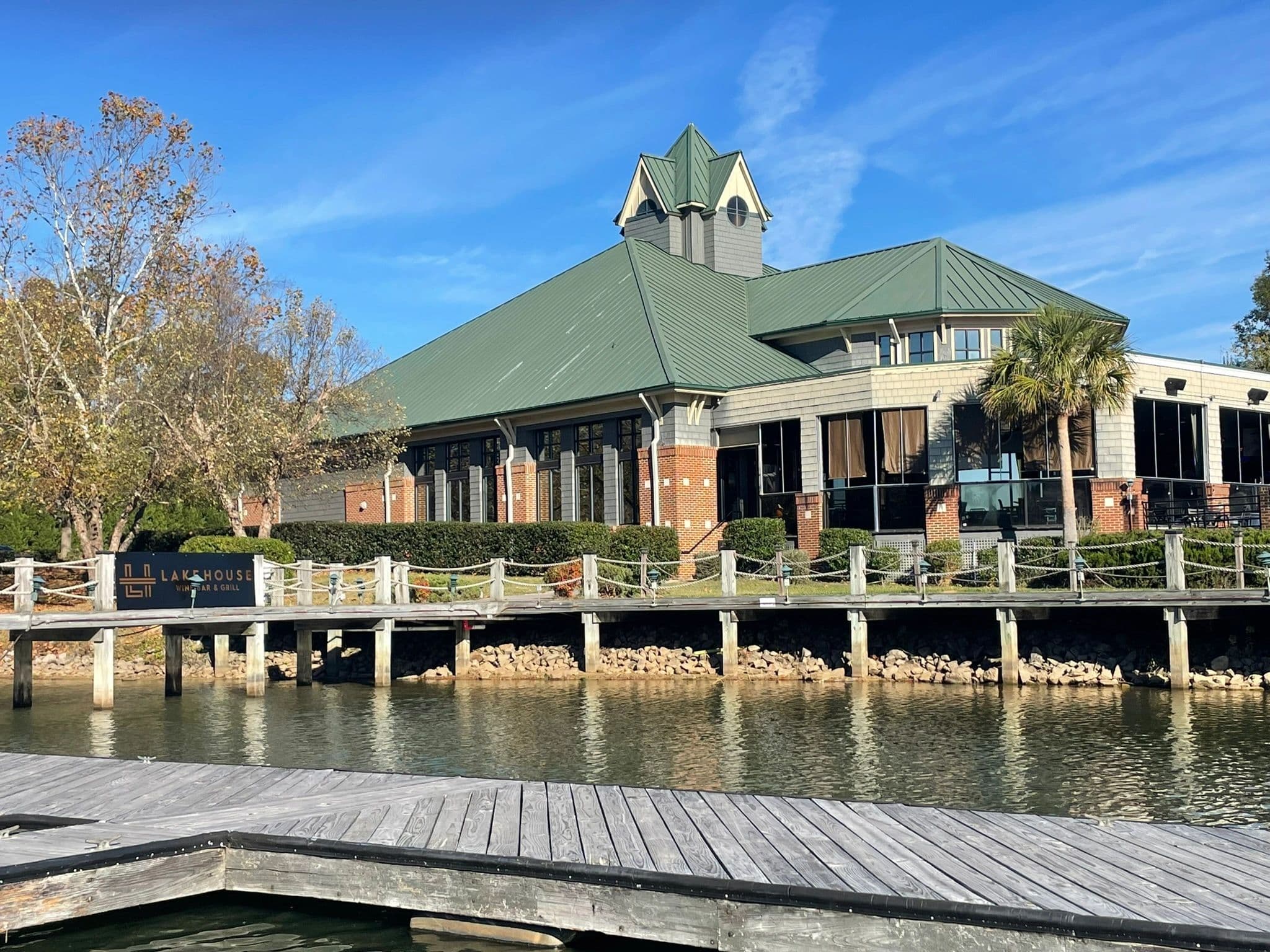 Waterfront building with green metal roof and dock